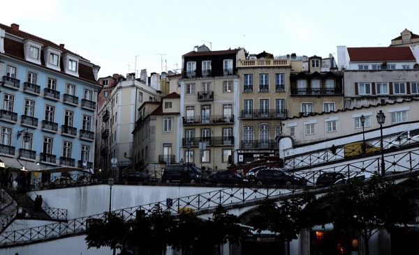Photo of hilly Lisbon scenery with buildings and traffic